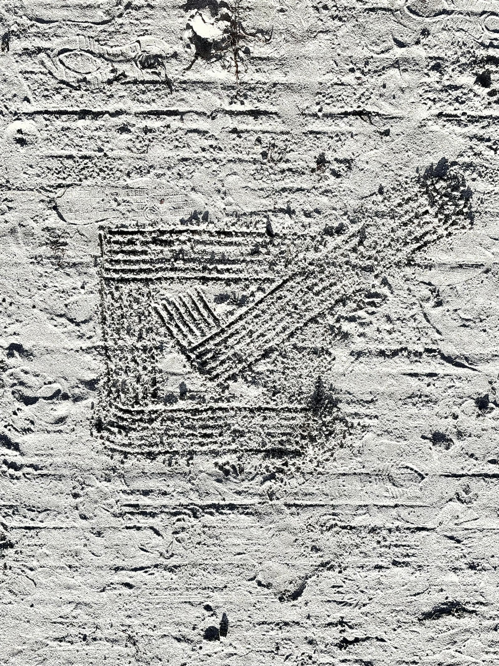 A large checkbox with a checkmark raked into sand, one choice marked