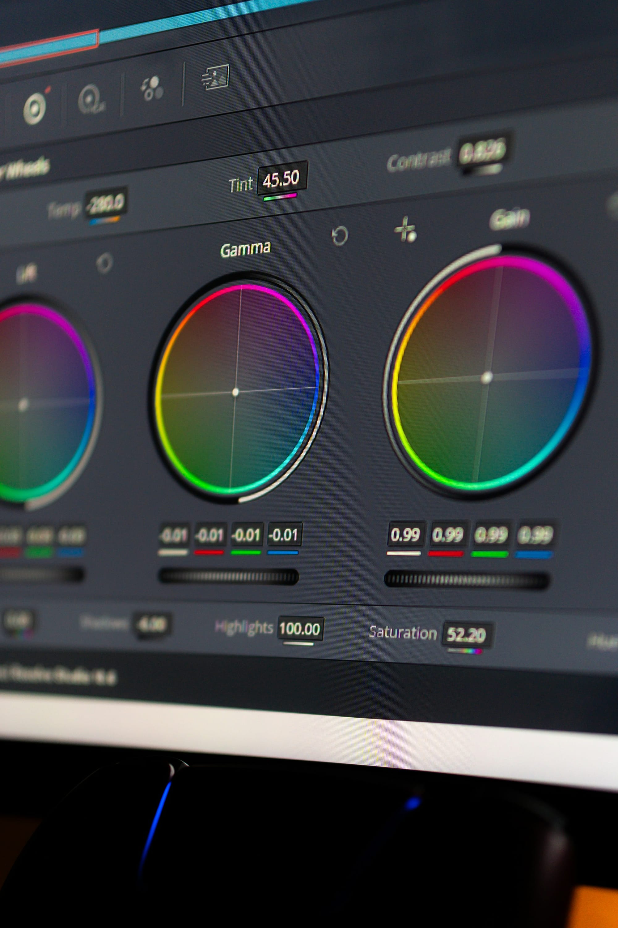 A computer screen showing color-grading wheels labeled Lift, Gamma, and Gain, with sliders for Contrast, Saturation, Shadows, and Highlights
