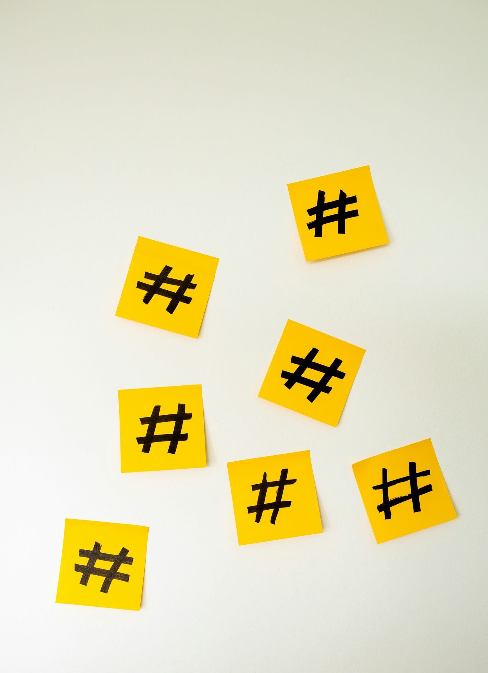 Yellow sticky notes marked with hashtag symbols on a wall