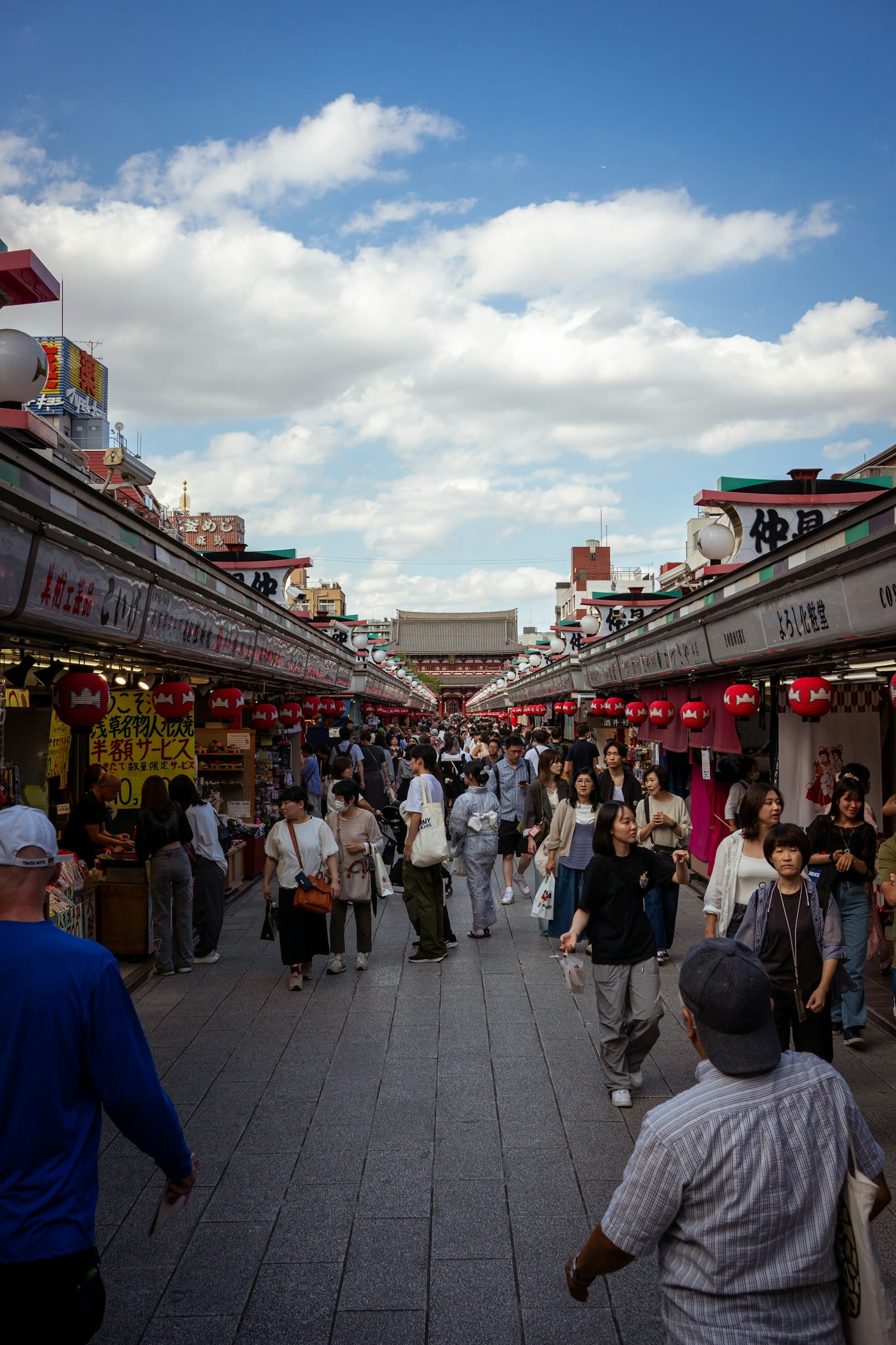 Crowded street market with stalls and shoppers