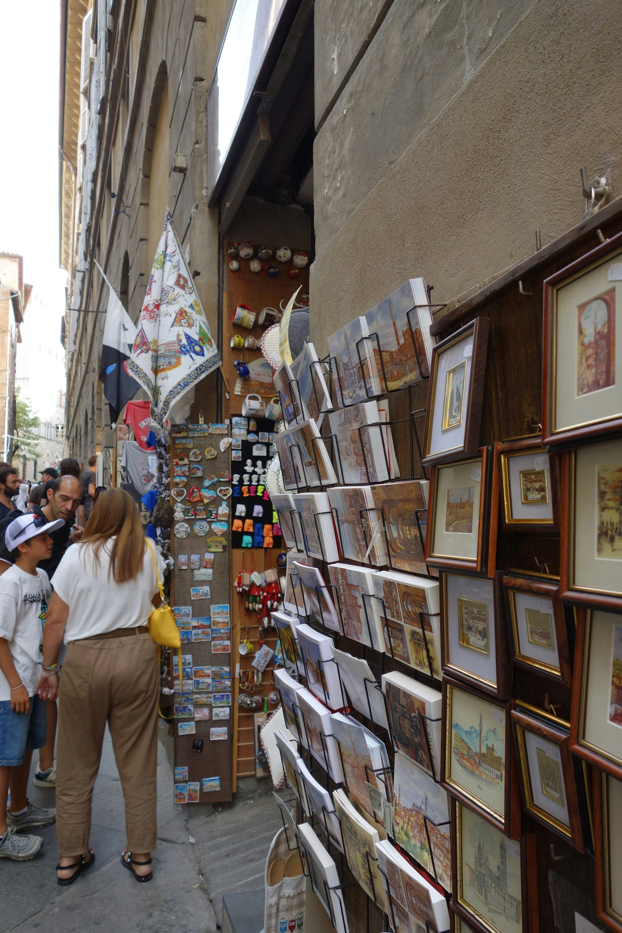 People browsing souvenirs at a street market stall