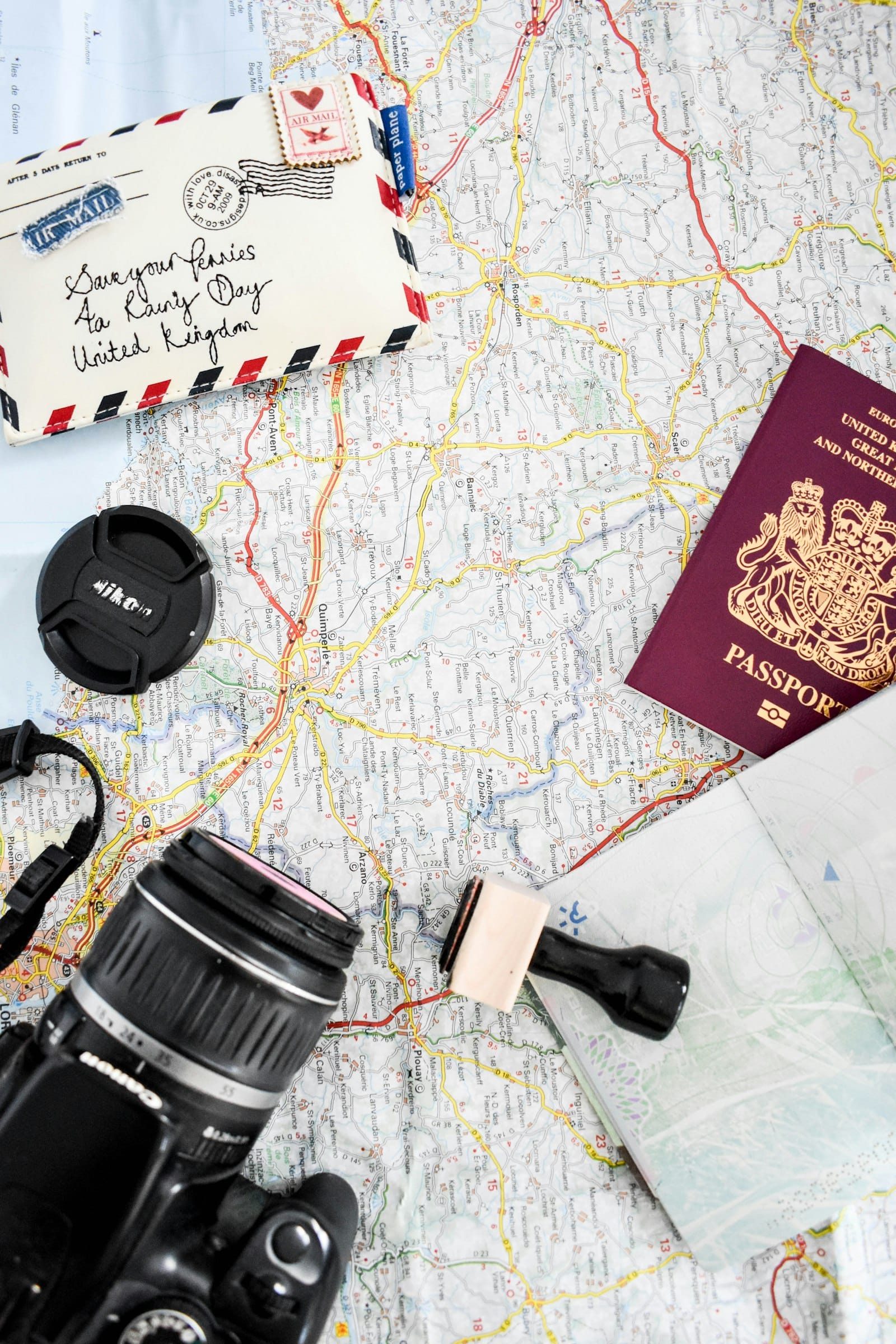 Passport, camera, and map laid out for travel planning