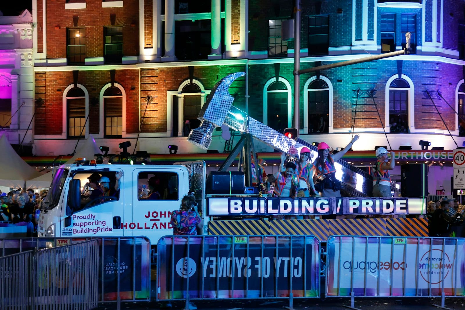 Night pride float celebration with crowd and lights