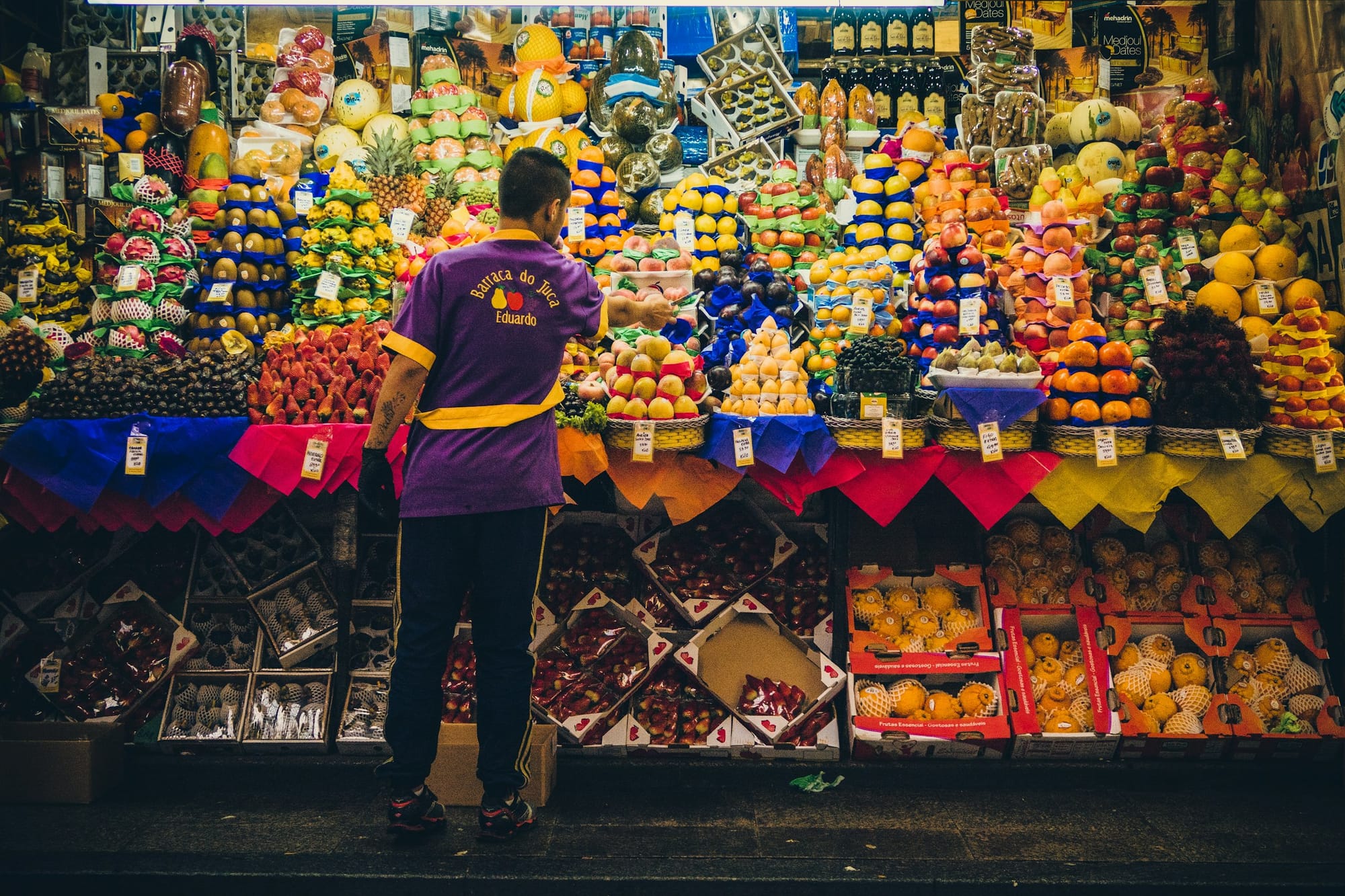Fruit stall inside São Paulo’s Mercadão market with stacked produce