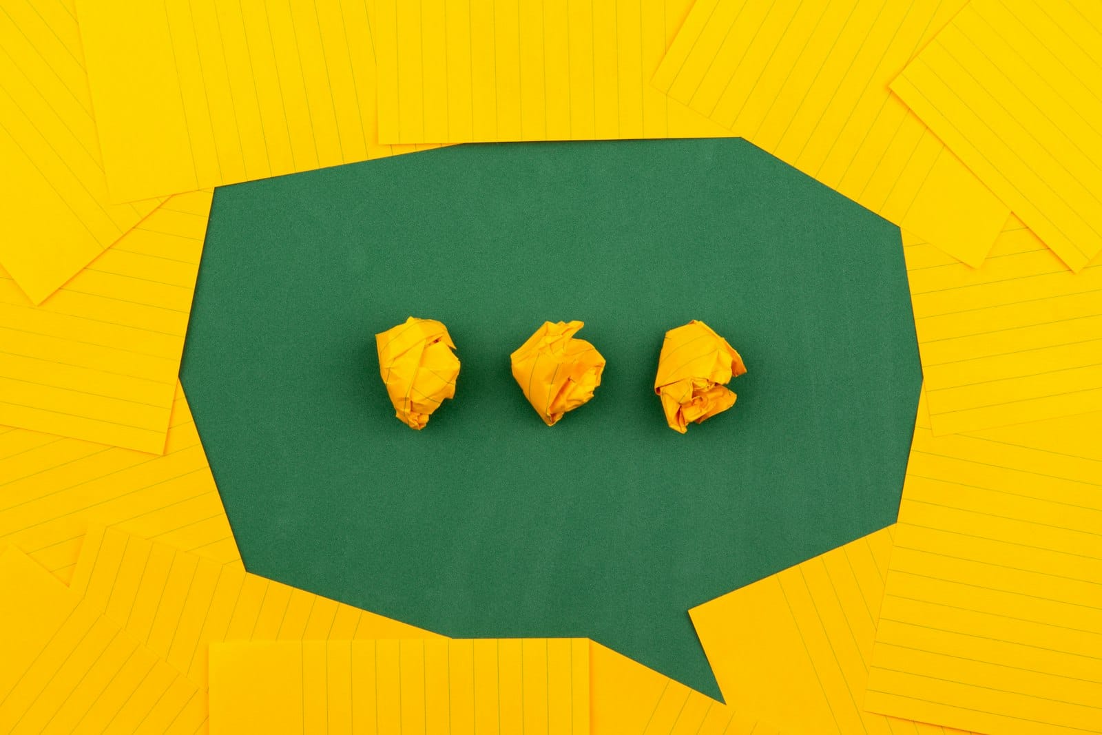 Yellow sticky notes forming a chat bubble with typing dots