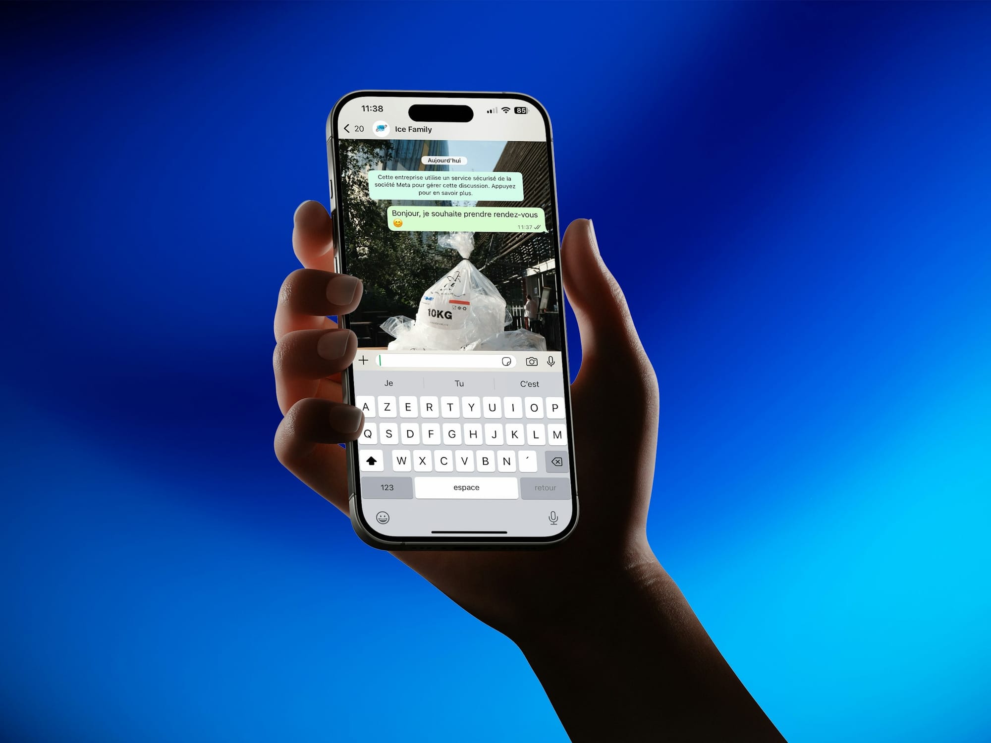 Hand holding a phone with a messaging app conversation open
