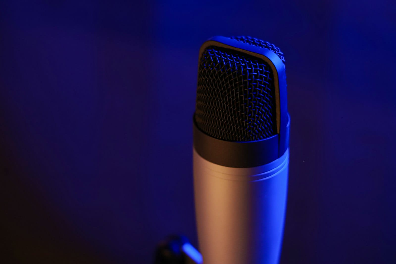 Studio condenser microphone close-up in blue and orange light
