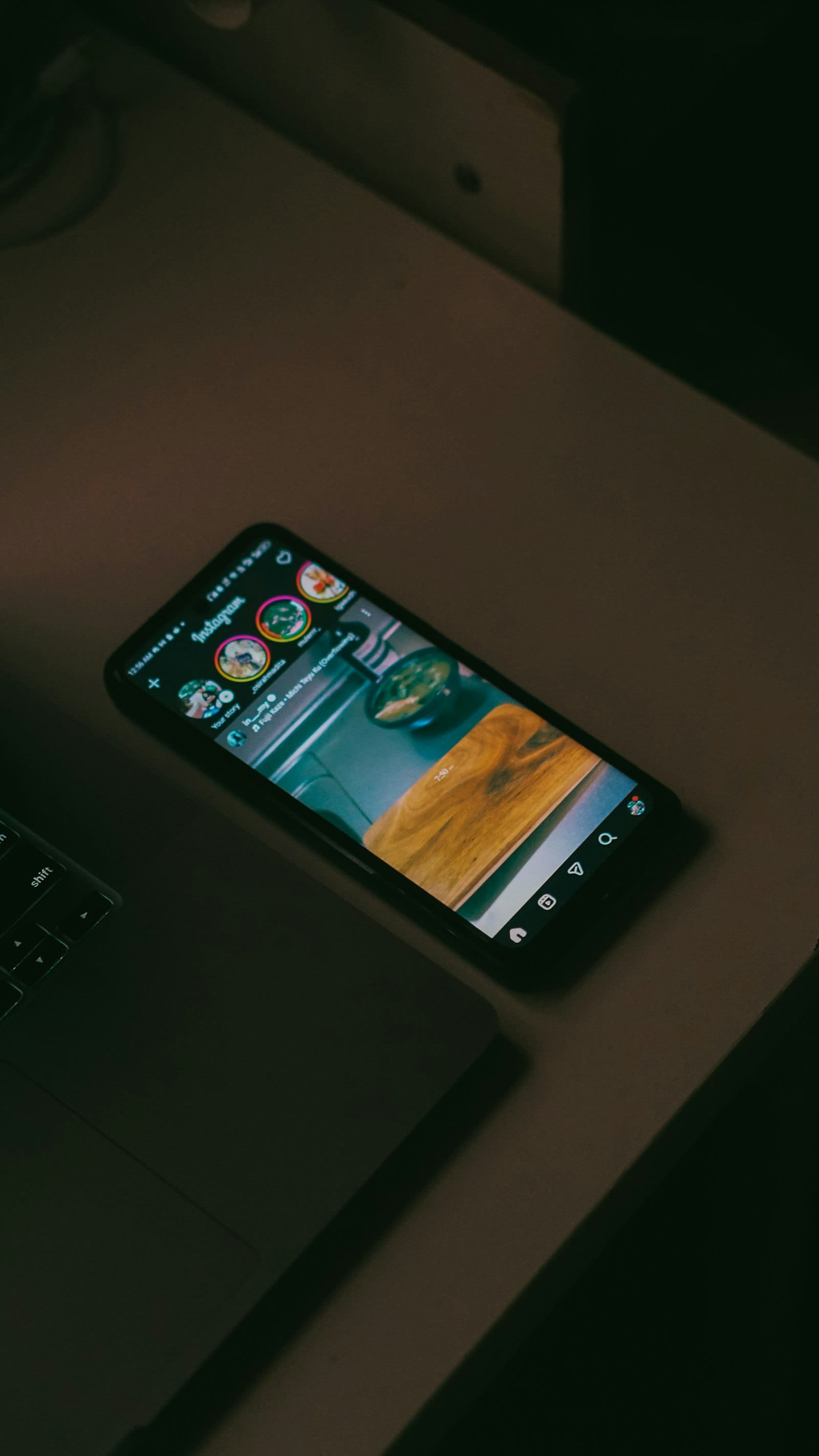 Phone showing Instagram on a desk