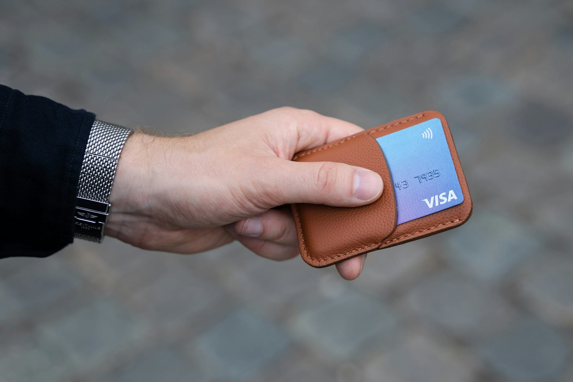Hand holding a wallet with a membership-style card