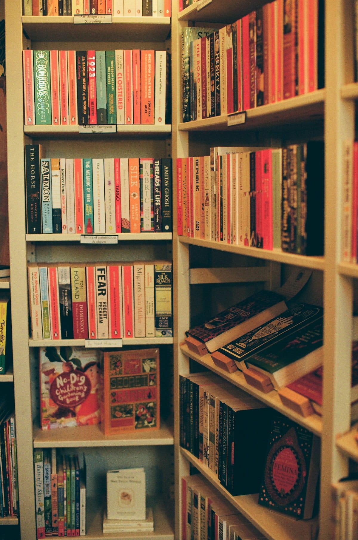 Bookstore shelves with labeled categories for browsing