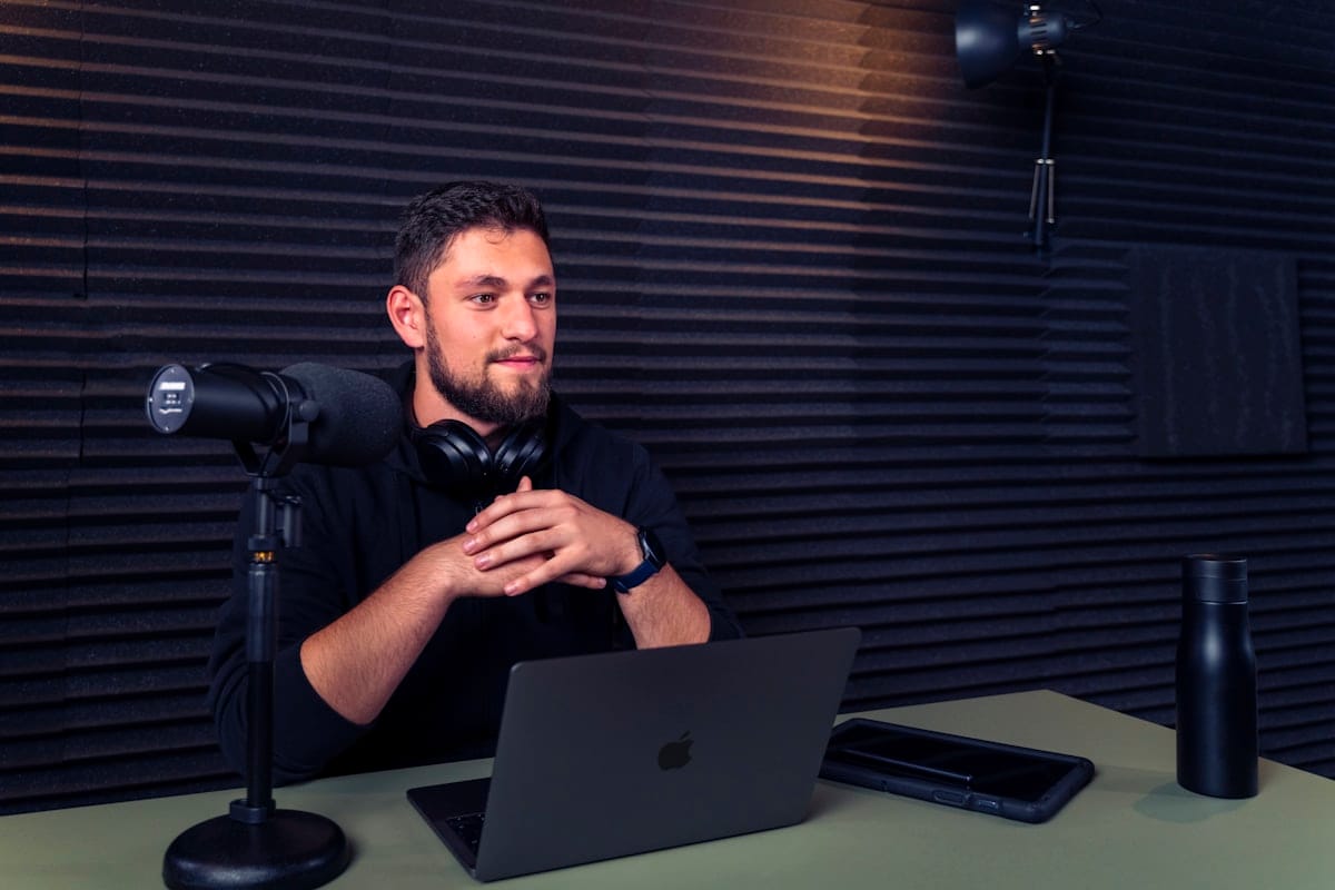 Creator podcast desk setup with mic and laptop