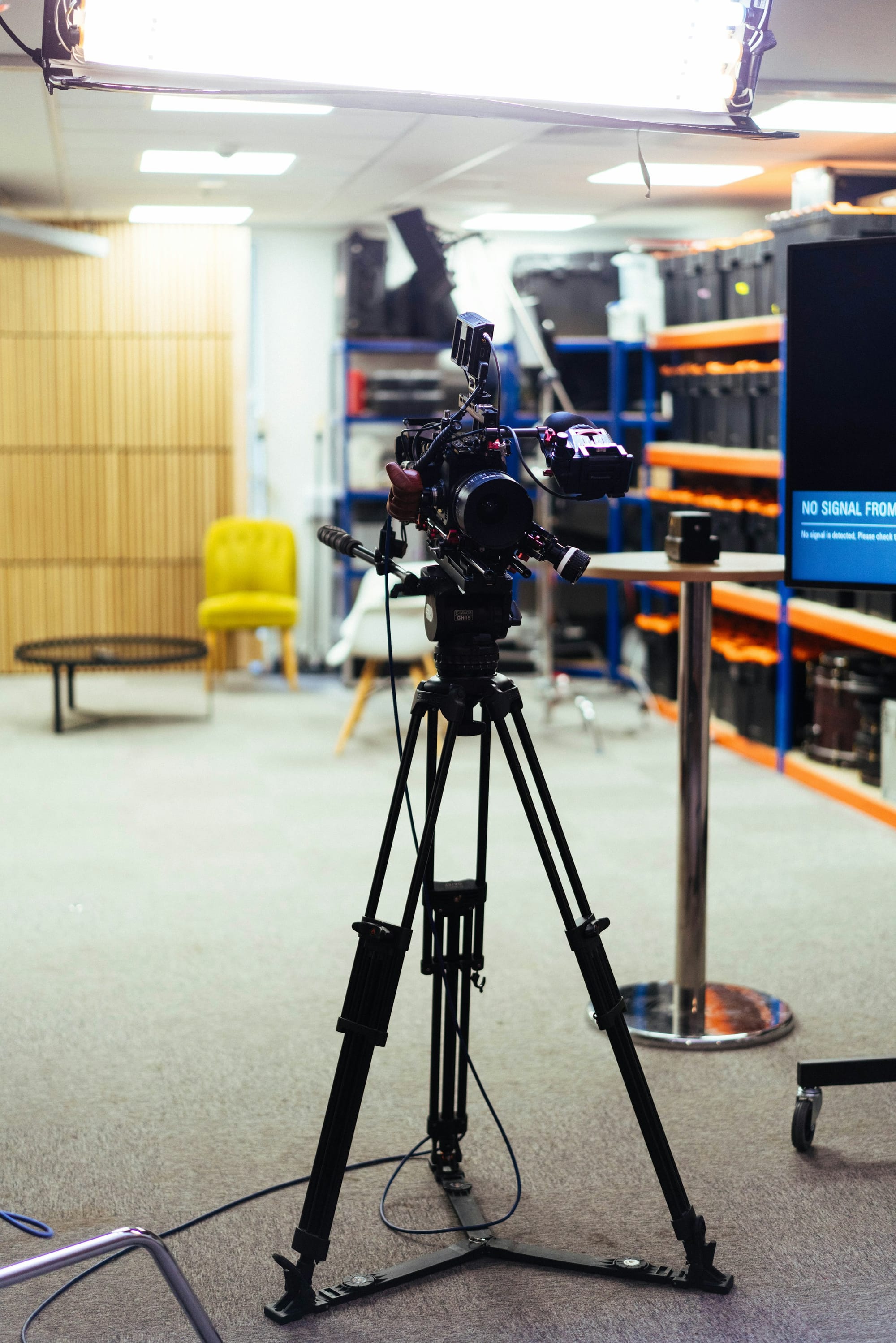 Professional video camera on a tripod in a studio