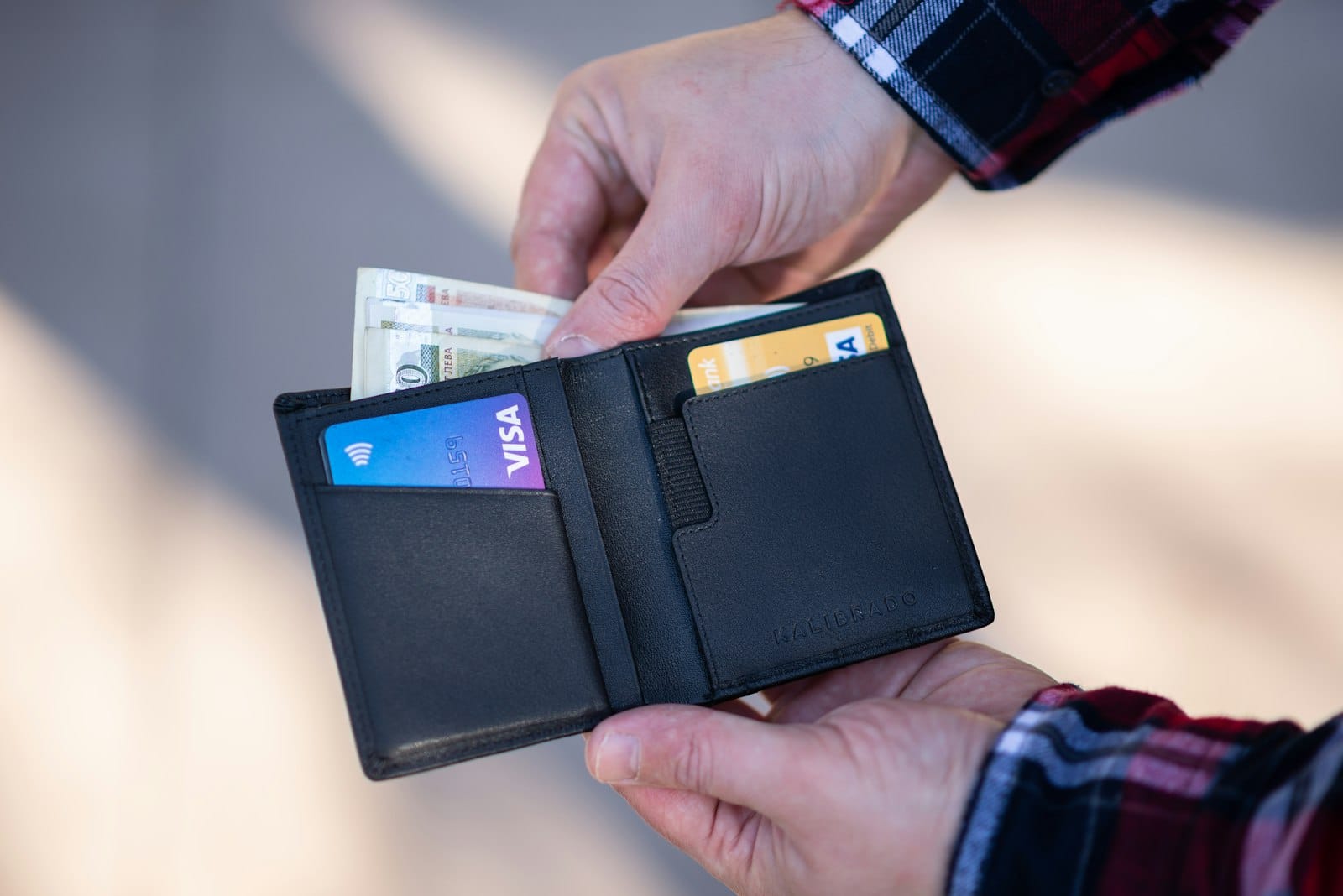 Open leather wallet with credit cards and cash