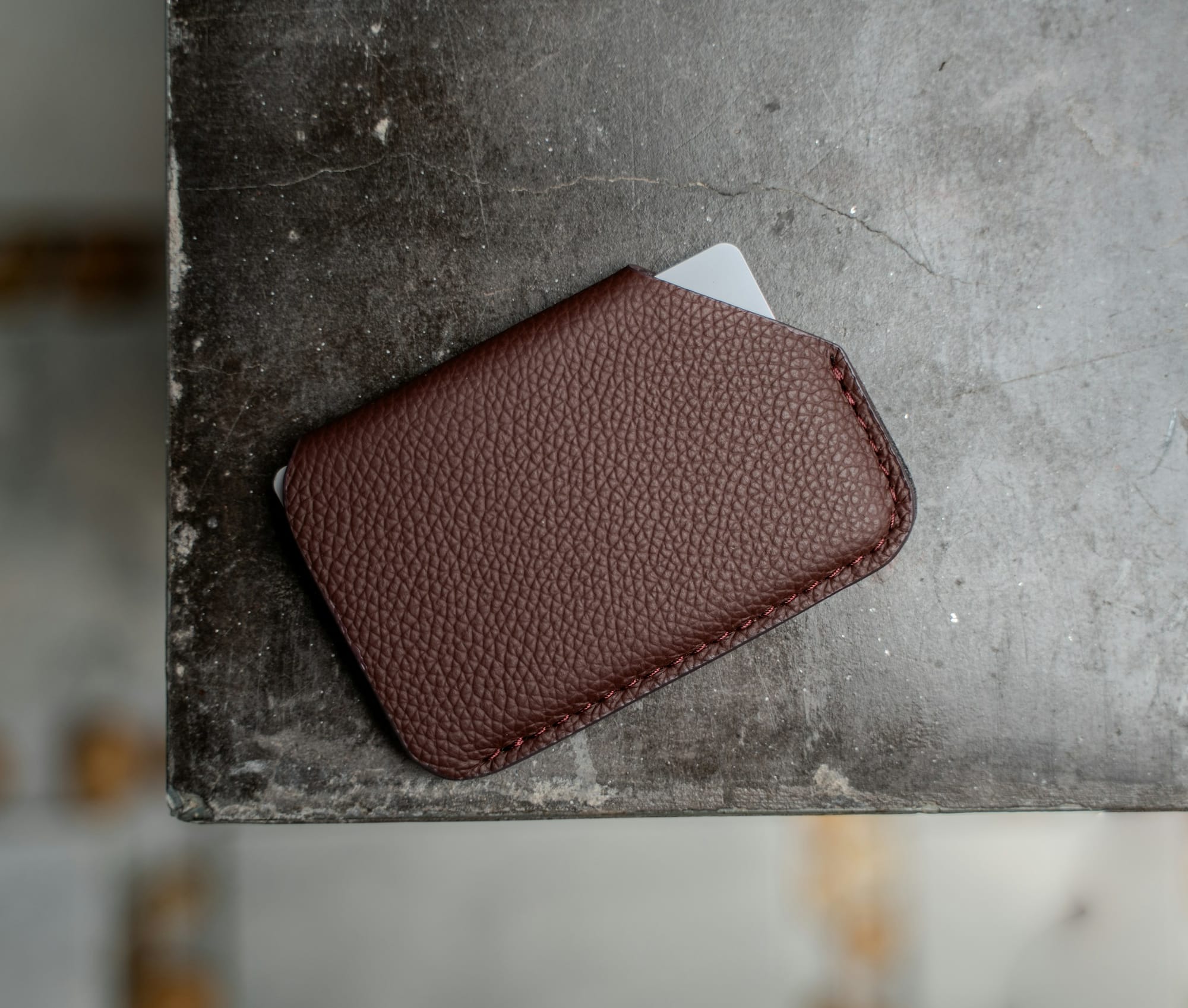 Brown leather cardholder with a card for wallet spend
