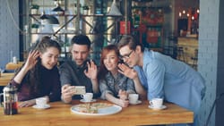Friends on a group video call at a cafe — Photo by Vitaly Gariev (@silverkblack) / Unsplash -5FmXX1YUks
